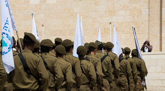 Jerusalem, Israel - April 12, 2018: Junior Israeli Defence Force soldiers in uniform pay homage at Jerusalem's Wailing Wall in the Old City