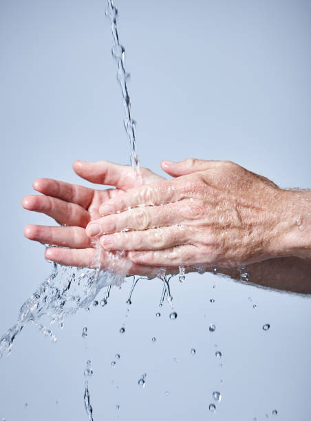 istock Senior adult washing hands under running water 964789544