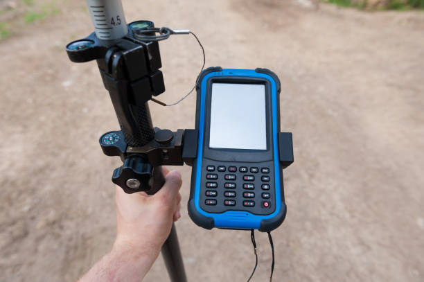 istock Man holding gps unit. Surveyor equipment. 964792620