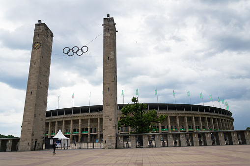 Berlin, Germany - May 15, 2018: Olympic rings symbol hanging over Olympic stadium from 1936 on May 15, 2018 in Berlin, Germany.