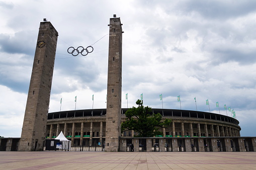 Berlin, Germany - May 15, 2018: Olympic rings symbol hanging over Olympic stadium from 1936 on May 15, 2018 in Berlin, Germany.