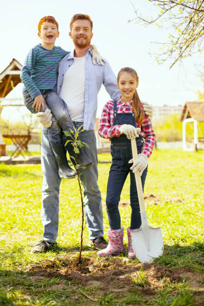 istock Nice joyful man standing with his children 964801592