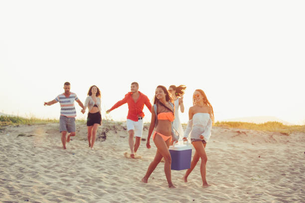 istock Young people enjoying summer vacations on beach 964804724