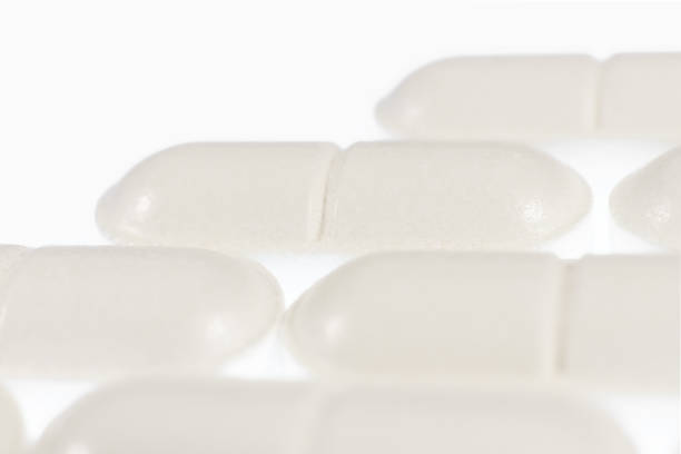 istock Stacked White Medicine Tablets. Pharmacy Pills Background. Macro Closeup. 964807796