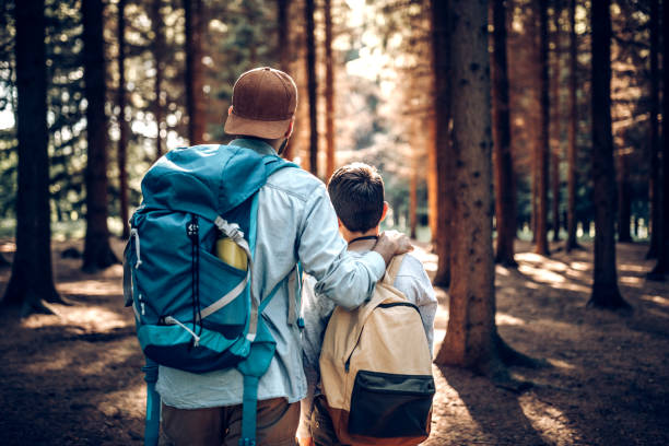 istock Father and son resting in woods 964809086