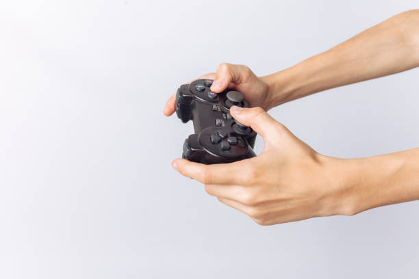 istock The image of hands that play games, stick, white background, insert text , advertising, 964809302