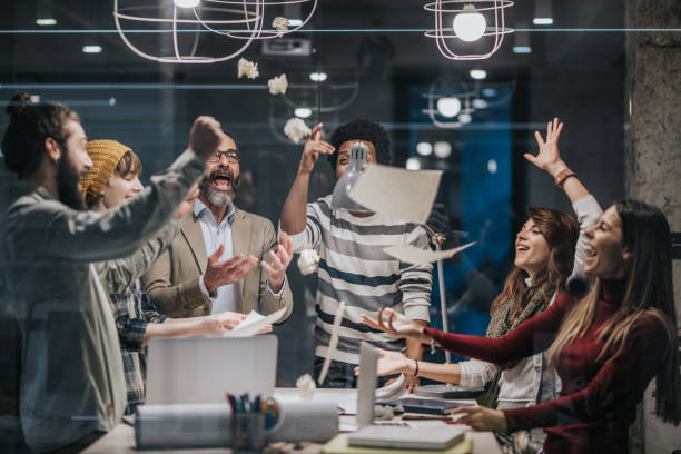 istock Joyful entrepreneurs having fun while throwing papers in the office. 964809618