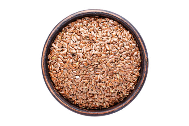 istock flax seeds in a plate isolated, on white background, top view 964811900