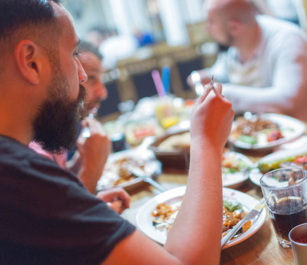 istock Arab men in restaurant enjoying Middle Eastern food 964817964