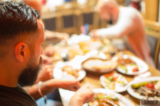 istock Arab men in restaurant enjoying Middle Eastern food 964817978