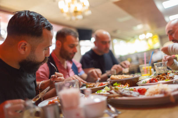 Arab men in restaurant enjoying Middle Eastern food