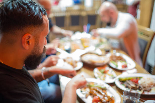 istock Arab men in restaurant enjoying Middle Eastern food 964820040