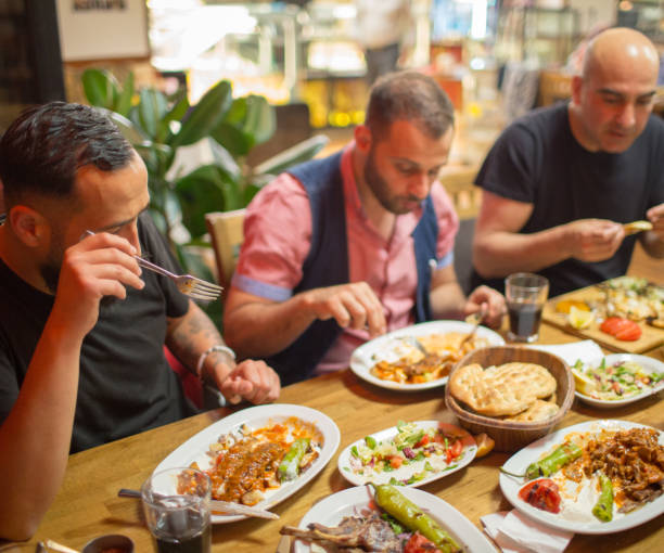 istock Arab men in restaurant enjoying Middle Eastern food 964820110
