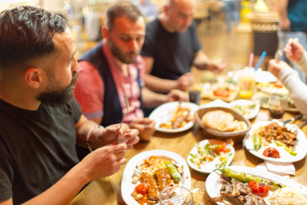 istock Arab men in restaurant enjoying Middle Eastern food 964820112