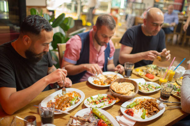 istock Arab men in restaurant enjoying Middle Eastern food 964820164