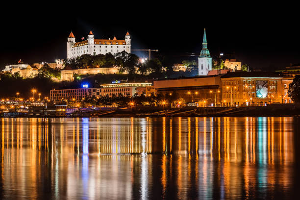 Bratislava at night Bratislava, Slovakia May 23, 2018: Bratislava at night, with the city lights reflected in the Danube river. On the top hill stands the Bratislava Castle built in the 9th century. bratislava castle bratislava castle fort stock pictures, royalty-free photos & images