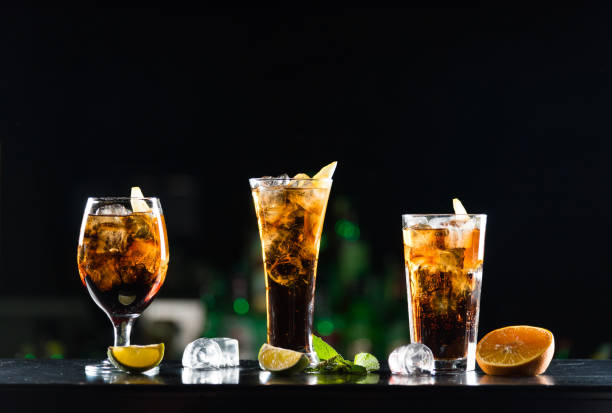 Alcoholic beverages whiskey and cola in glasses of different shapes on the bar table. Alcoholic beverages whiskey and cola in glasses of different shapes on the bar table. Photo. glass of bourbon stock pictures, royalty-free photos & images