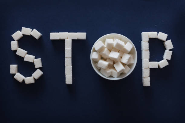istock Sugar STOP sign on dark blue background 964831442