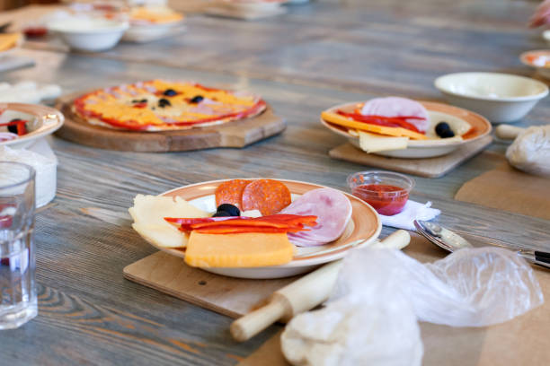 istock cooking class, culinary. food and people concept, desktop getting ready for work, ingredients for italian pizza 964831590