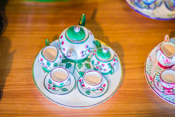 istock Vintage Thai's style handmade porcelain tea cups set. Beautiful traditional Thai five-colored porcelain ceramic tea cup set. Benjarong Porcelain tea cups for sale in the flea market, Thailand. 964832352