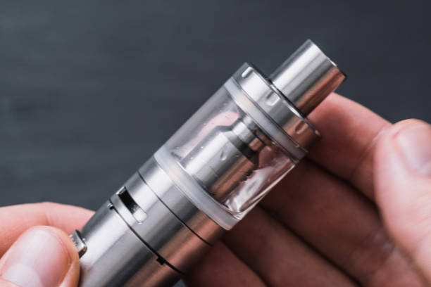 man's hand. Electronic cigarette, vape Vaping device in in the