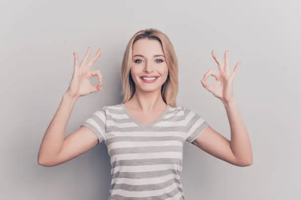 Photo of Portrait of satisfied confident charming pretty beautiful excited smart joyful nice-looking with short hair freelancer demonstrating double two ok signs with hands isolated on gray background