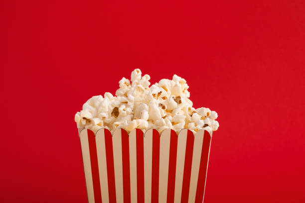 istock Bucket of popcorn on red background 964835990