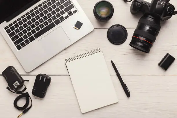 Photo of Photographer equipment and blank notepad