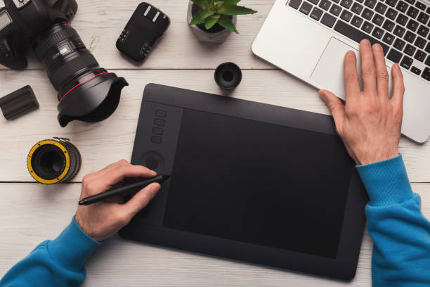 istock Designer hand with graphic tablet and keyboard 964838724