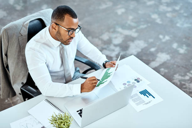 He finishes every day with a success High angle shot of a young businessman working in an office stubble male african ethnicity facial hair stock pictures, royalty-free photos & images