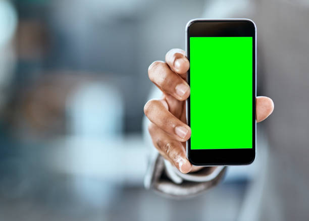 Sign up with the network that keeps you connected Closeup shot of an unrecognizable businessman holding up a cellphone with a green screen in an office chroma key stock pictures, royalty-free photos & images