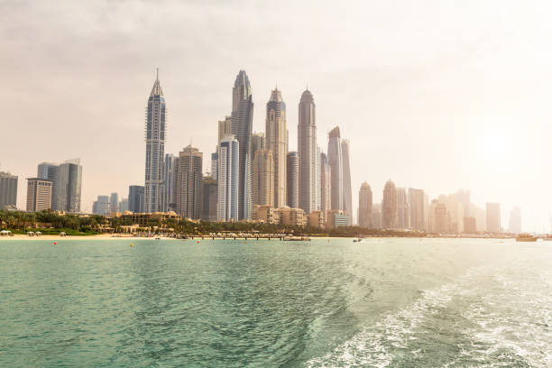 istock Panoramic view of Dubai from sea at sunset during a cruise 964839028