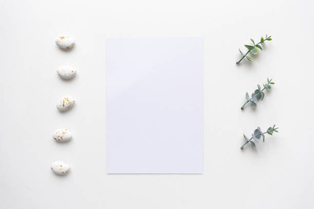 istock Wedding invitation card on white marble with oregano branches. Top view. 964839108