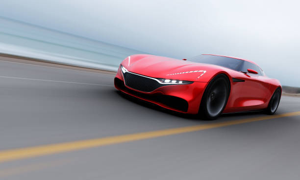 istock red car driving on a road by sea 964839388