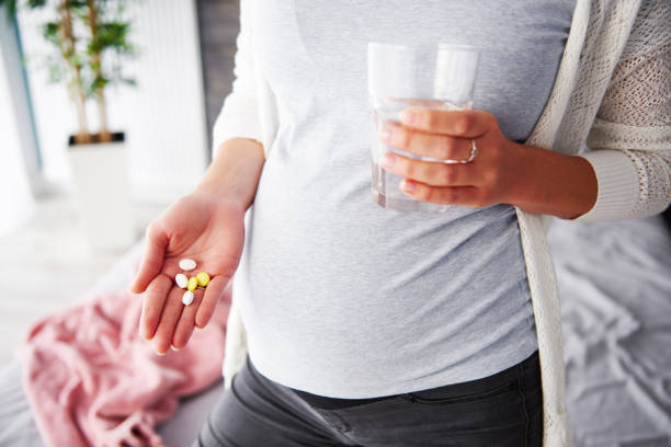istock Pregnant woman taking medicines 964847070