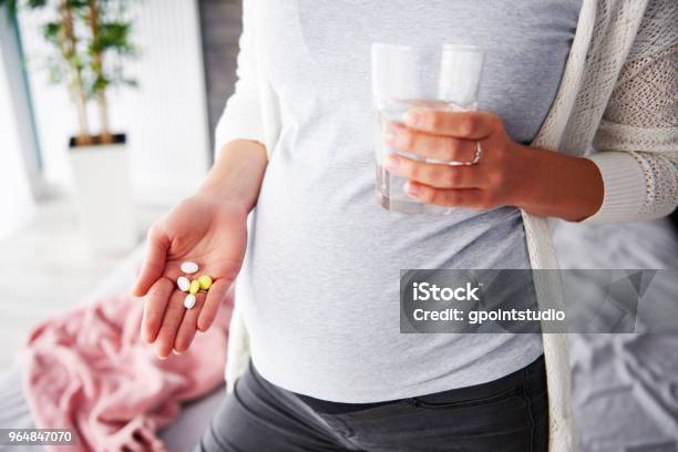 Pregnant Woman Taking Medicines Stock Photo - Download Image Now - Pregnant, Nutritional Supplement, Folic Acid