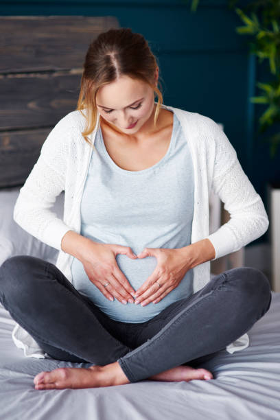 istock Affectionate pregnant woman touching her stomach 964847638