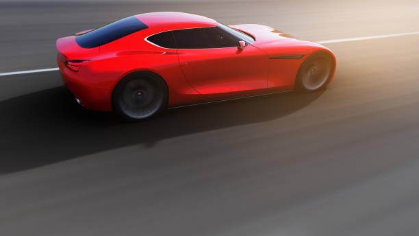 istock red car driving on a road 964848110