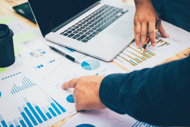 istock Two business people discussion about summary graph in office room. 964851436