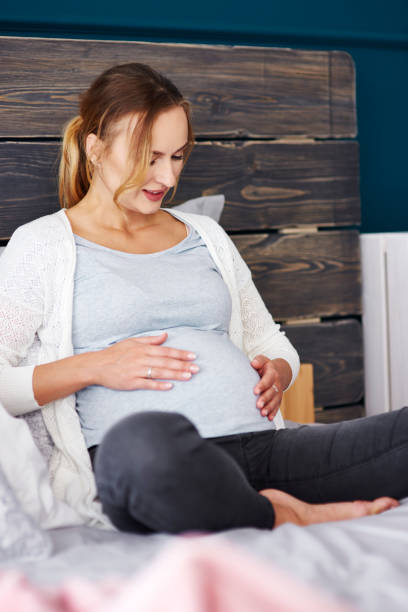 istock Young mother resting at bedroom 964858388
