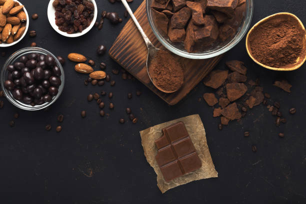 istock Top view on chocolate and nuts on black background 964862806