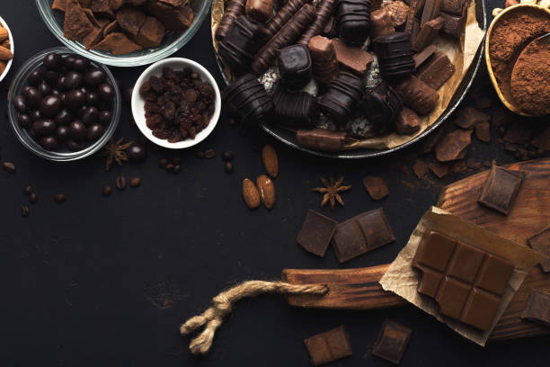 istock Top view on chocolate and nuts on black background 964862930