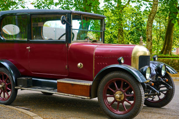 A pair of claxon horns mounted on the fender of an antique fire engine.
