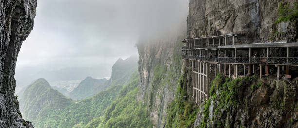 istock panoramic view from Tianmen mountain to the valley with mountain roads 964863794