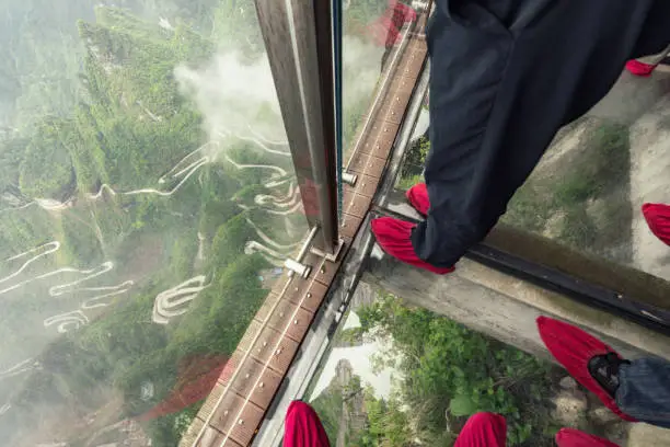 people on glass walk at tianmen mountain in zhangjiajie
