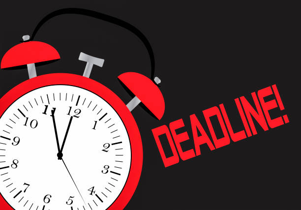 istock An alarm clock and chalk board with the word deadline 964867300