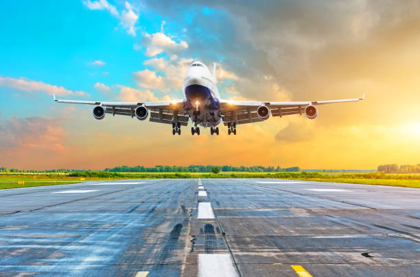 istock Aircraft with four engines flying arrival landing on a runway in the evening during a bright red gradient sunset. 964871436