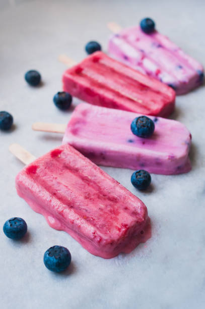 istock Pink and purple ice cream popsicles 964875090