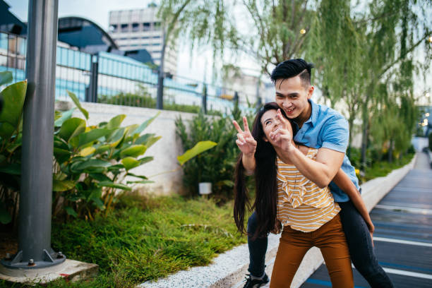 istock Woman carrying a man on her back 964877286