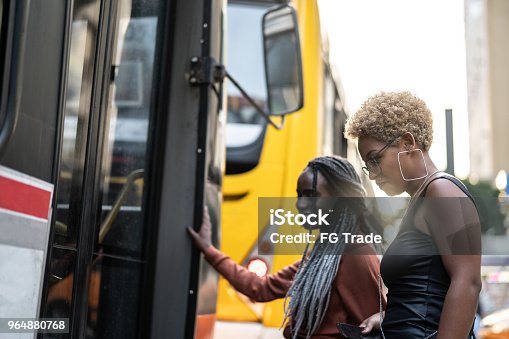 istock Two Businesswoman getting on the bus, Brazil 964880768